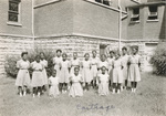 Group Photo of 16 Adolescent School Girls outside Chapel by Sisters of the Good Shepherd