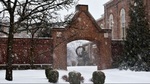 Background Image: Snowy View of South Arch into Courtyard between Chapel and St. Mary's Hall