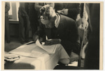 Man signing documents at the Baltic University in Exile