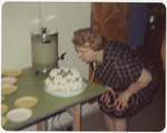 Woman blows out candles on a cake at the Boston National Convention, 1963