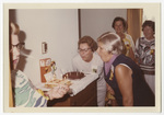 Women blowing out candles on a birthday cake