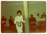 Woman holding pitcher and cup at Boston NED Convention