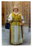 Woman holding a cross in traditional Lithuanian dress