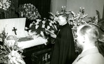 A priest praying at the funeral