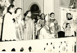 Bishop, priests, and altar servers celebrating Mass